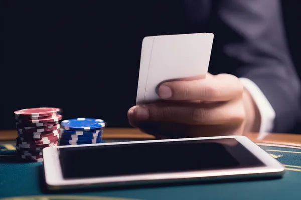 A young woman relaxing with her phone while dynamic casino elements float around her, illustrating the smooth mobile experience offered by the 1XBED app.