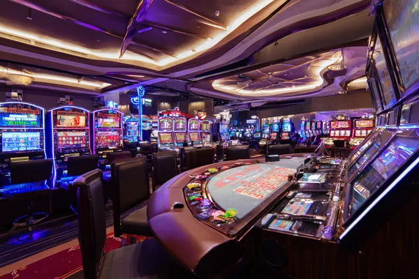 A glowing roulette wheel with cascading chips, symbolizing the engaging live and instant-win games available on 1XBED.