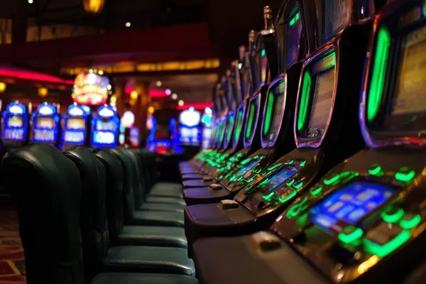 A woman in a luxurious green gown next to an ornate roulette wheel, capturing the upscale casino mood of 1XBED.